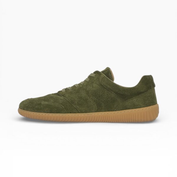 Side profile of a barefoot green suede shoe